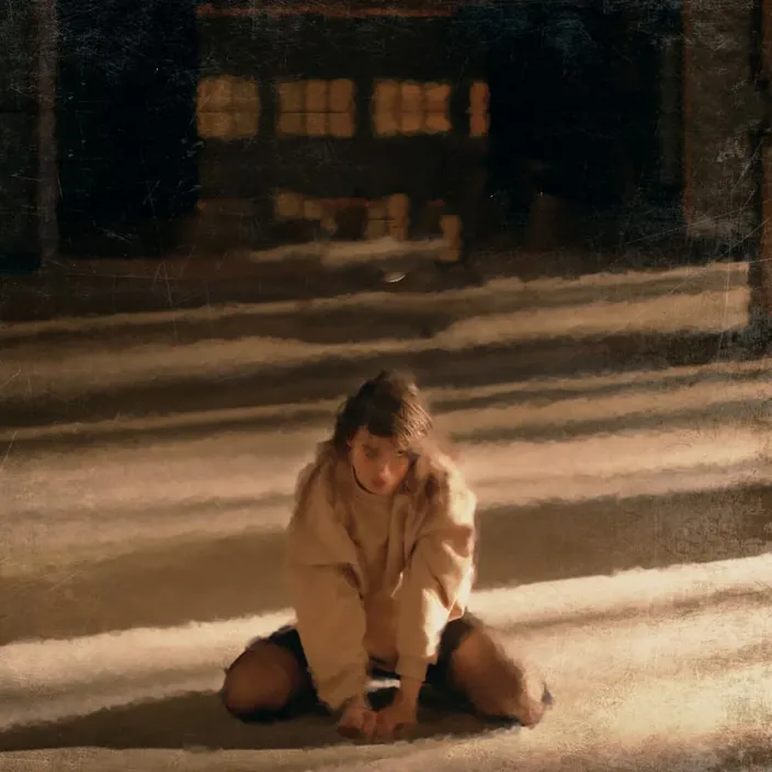 a young girl sitting on the ground in the snow