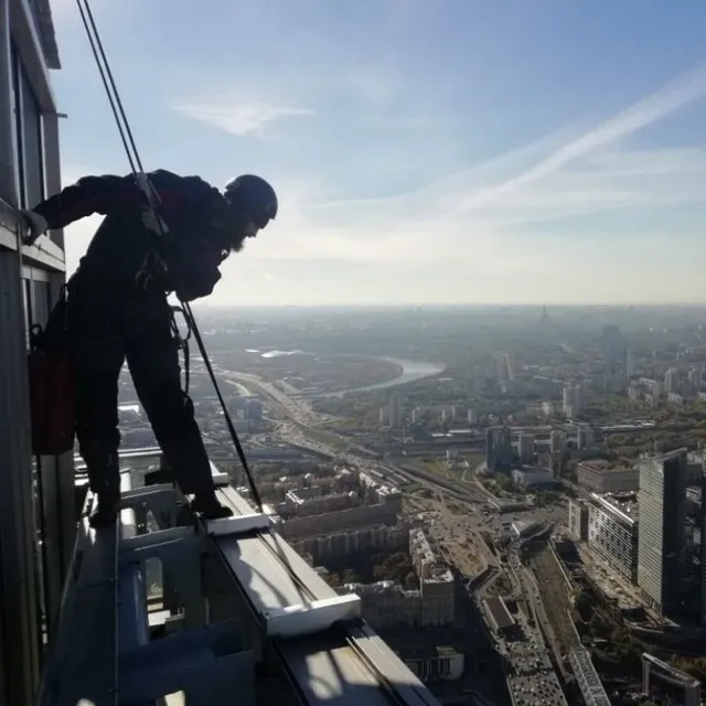 a man standing on top of a tall building