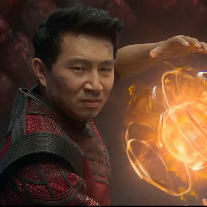 a man holding a glowing object in his hand