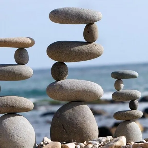 a pile of rocks sitting on top of a beach