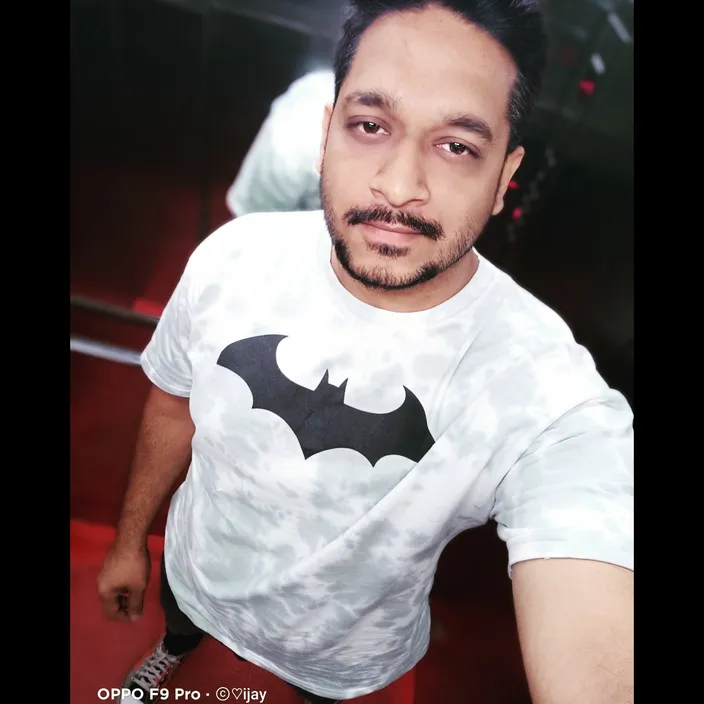 a man with a mustache and a batman t - shirt