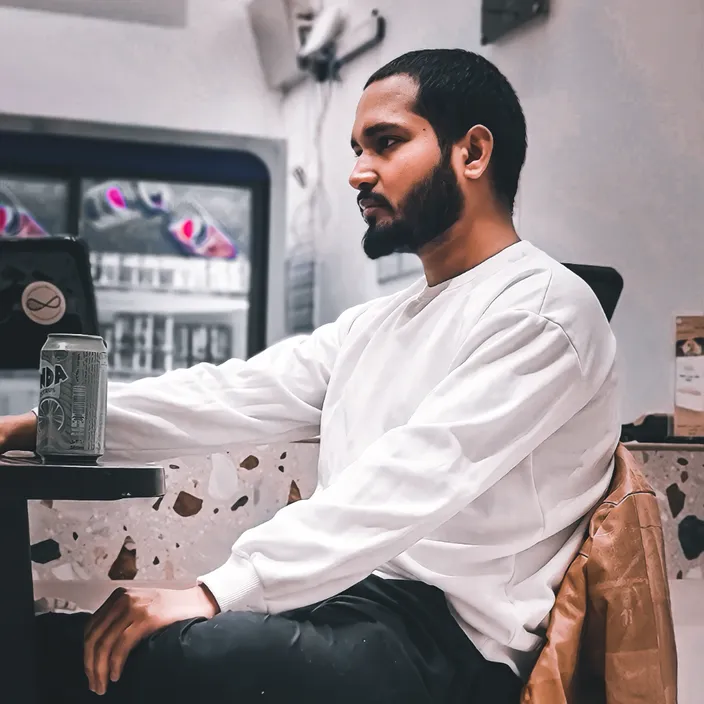 a man sitting in a chair with a laptop