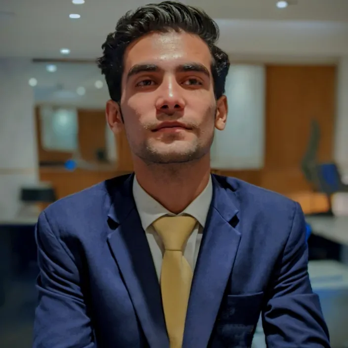 a man in a blue suit and yellow tie