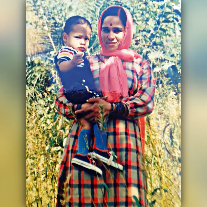 a woman holding a child in a field