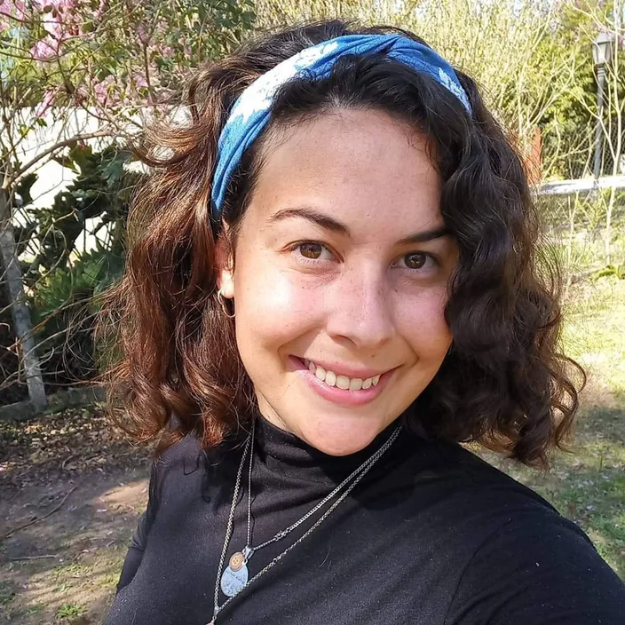 a woman wearing a black shirt and a blue headband