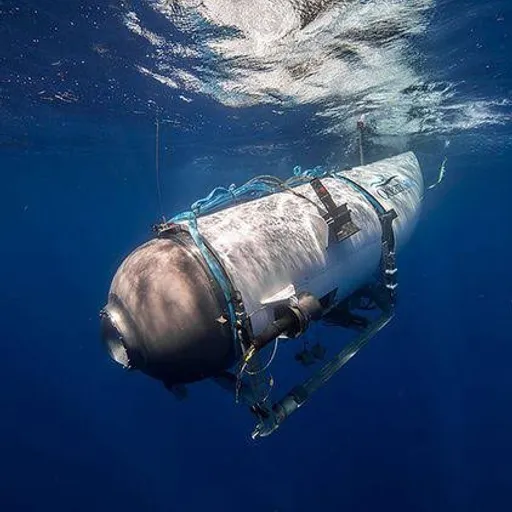 a large pipe floating in the ocean next to a boat