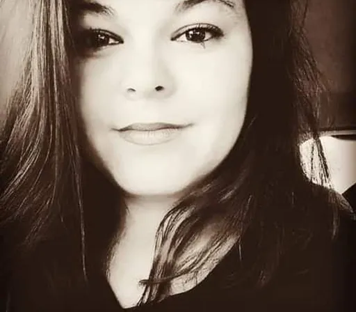 a black and white photo of a woman with long hair