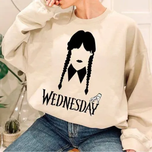 a woman wearing a sweatshirt with the words wednesday on it