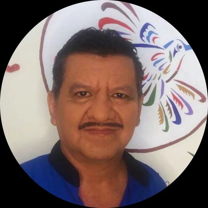 a man with a mustache and a blue shirt