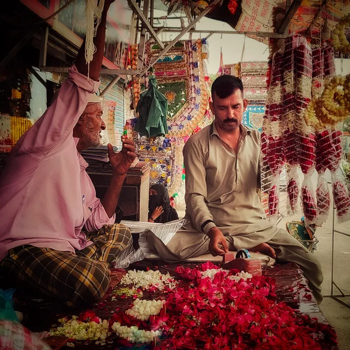 a woman buying flowers from him