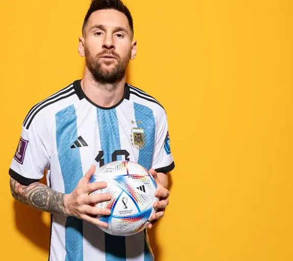 Messi holding a soccer ball in his hands