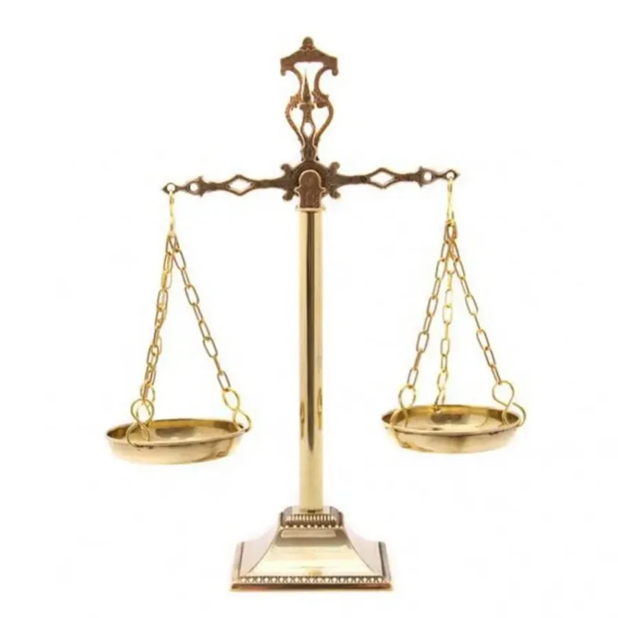 a golden balance scale with a white background