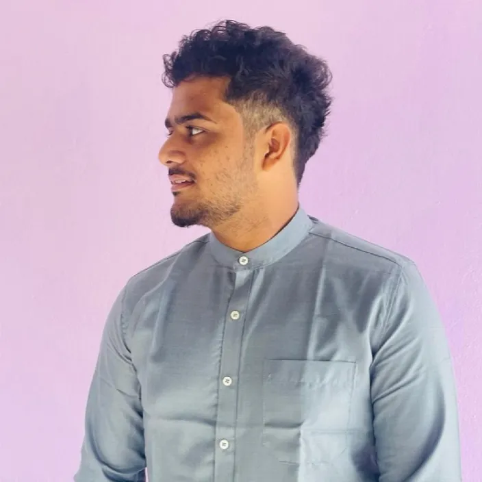 a man standing in front of a purple wall