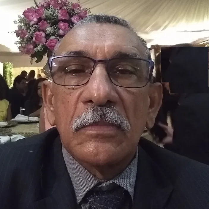 a man wearing glasses and a suit and tie