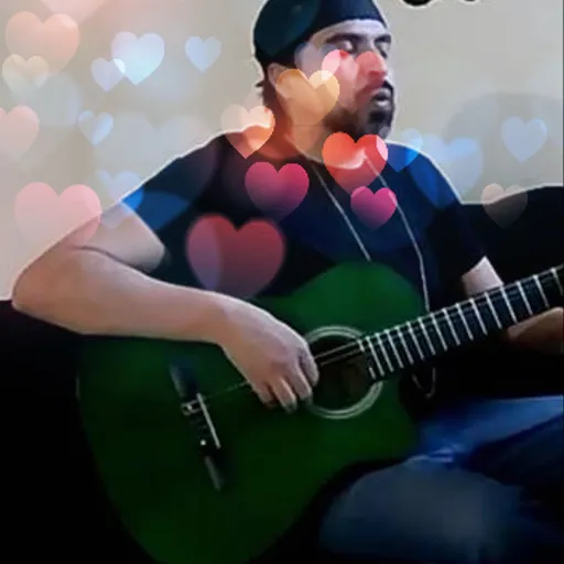 a man sitting on a couch playing a guitar