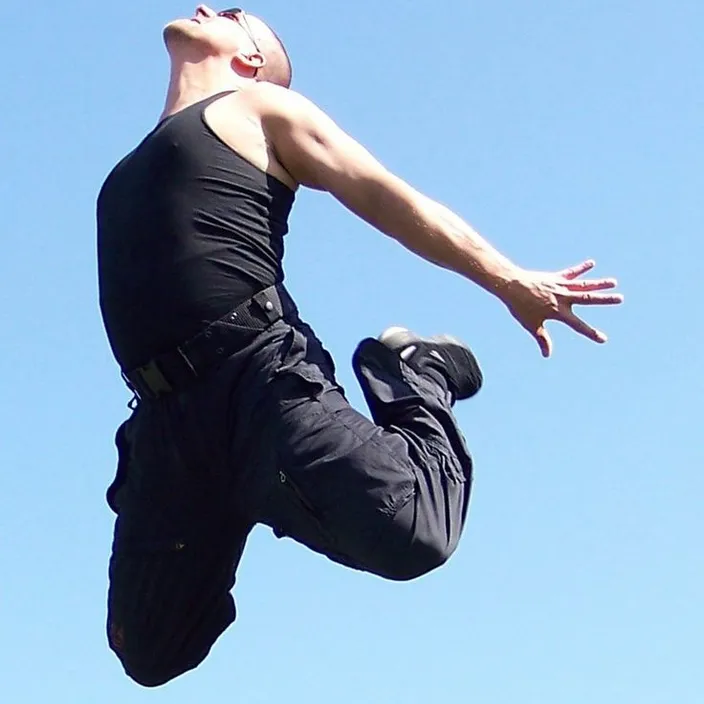 a man flying through the air while riding a skateboard