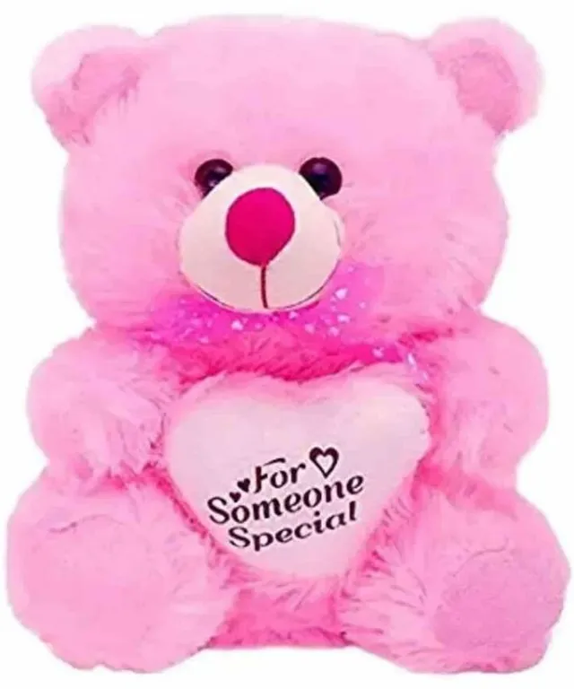 a pink teddy bear is holding a heart