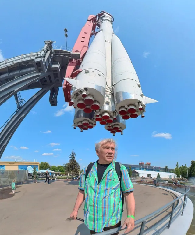 a man standing next to a space shuttle