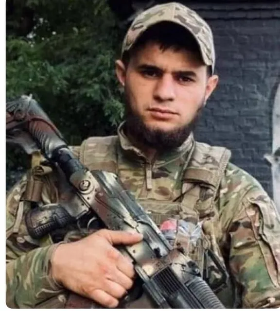 a man with a beard holding a gun