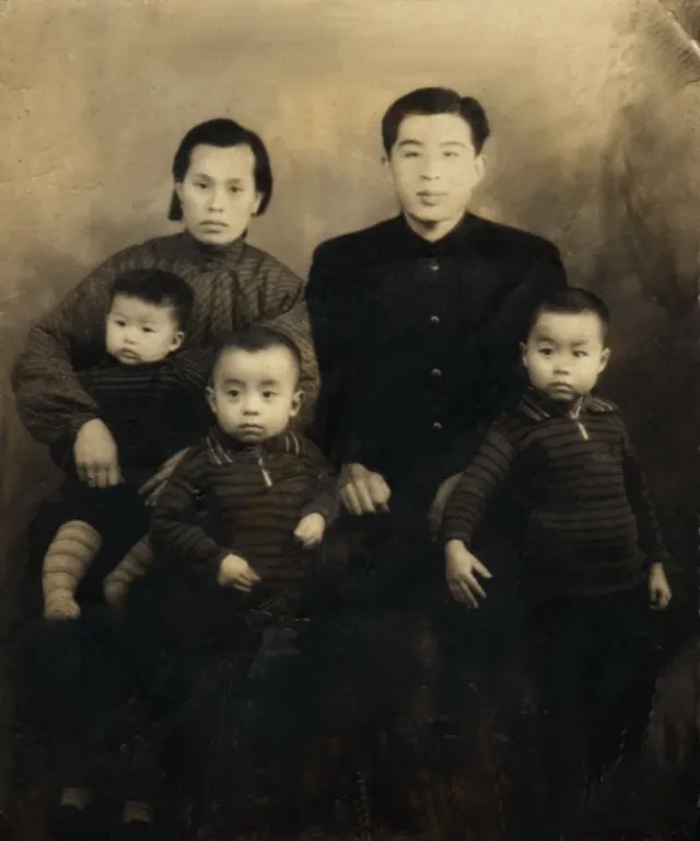 an old photo of a family posing for a picture