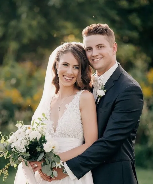 a bride and groom posing for a picture