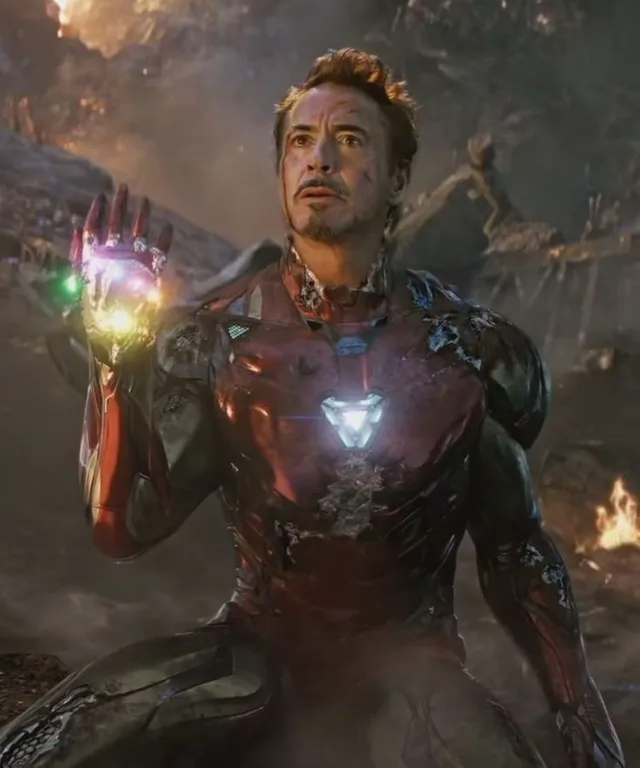 a man in a suit holding a glowing glove