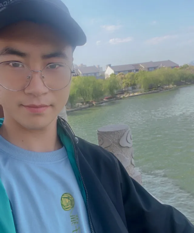 a young man wearing glasses and a hat