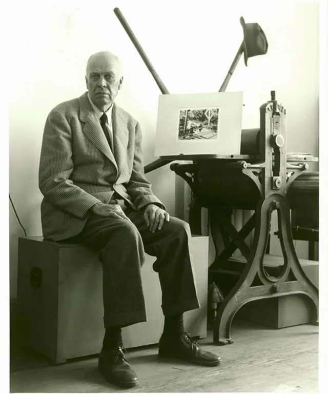 a black and white photo of a man sitting in a chair