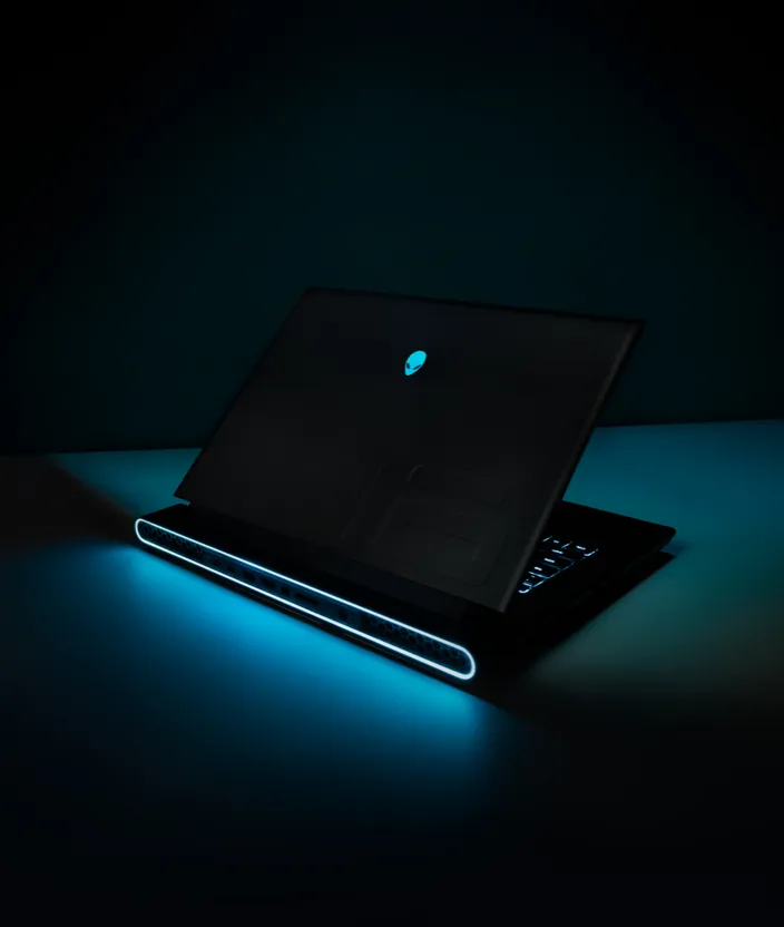 a laptop computer lit up in the dark. computer, personal computer, laptop, netbook, azure, gadget, computer hardware, laptop part, output device, electric blue