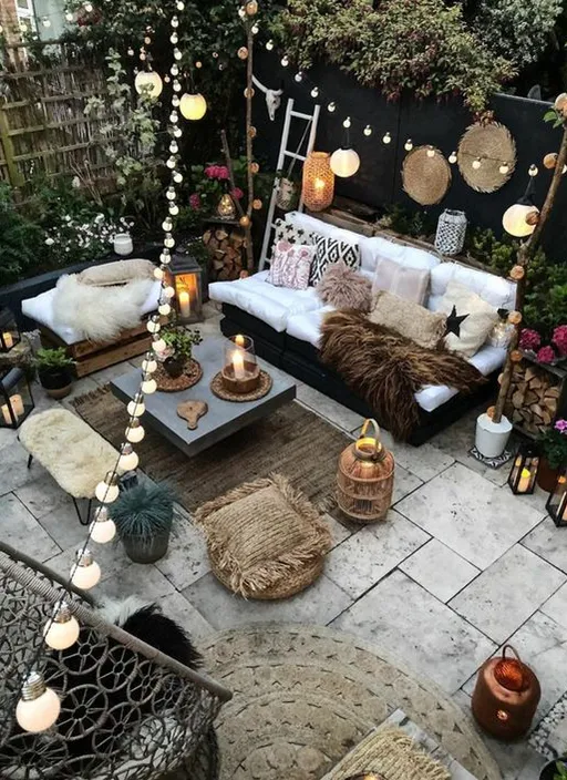 a patio with a couch, table and lights