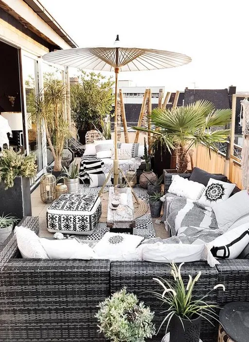 A Patio with a Couch, Table, and Umbrella. Add a sign that says 'Bar' or 'Restaurant'.