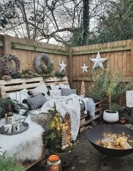 a backyard with a fire pit and a wooden fence