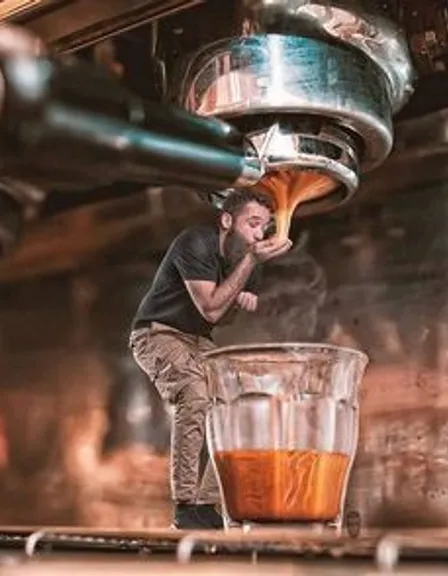 a man is pouring something into a glass