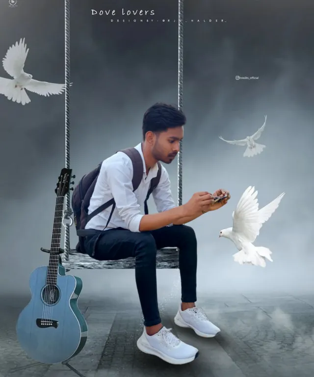 a man sitting on a swing next to a white bird