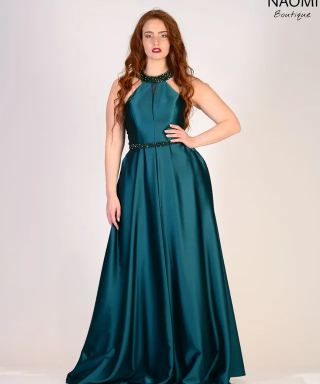 a woman in a green dress posing for a picture