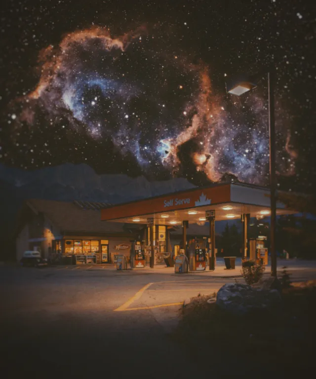 a gas station with a sky full of stars