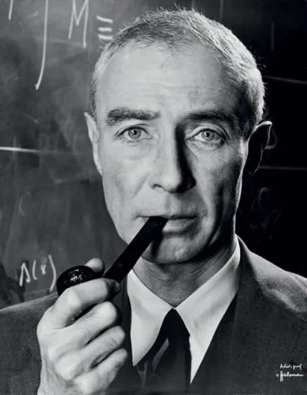 a black and white photo of a man smoking a pipe