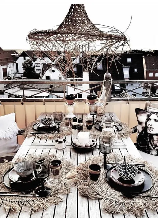 a wooden table topped with plates and cups