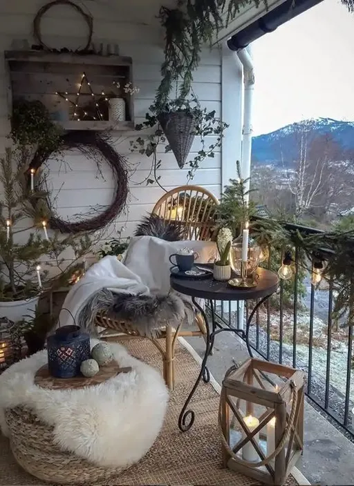 a balcony with a table, chairs, and wreaths on it, plus some festive flair (pumpkins, etc.). add some festive flair (pumpkins, etc.)