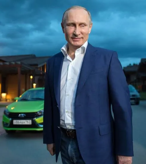 a man standing in front of a green car