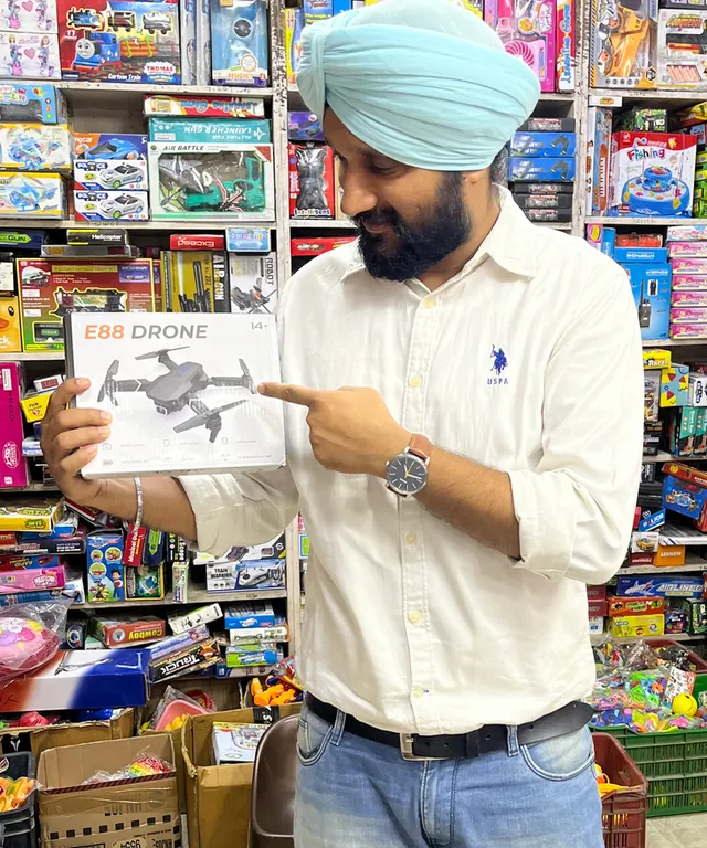 a man in a turban pointing at a book