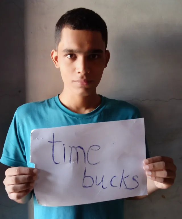 a young boy holding a sign that says time bucks