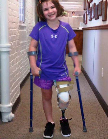 a little girl with a broken arm and a broken leg