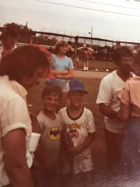 a group of people standing next to each other on a field