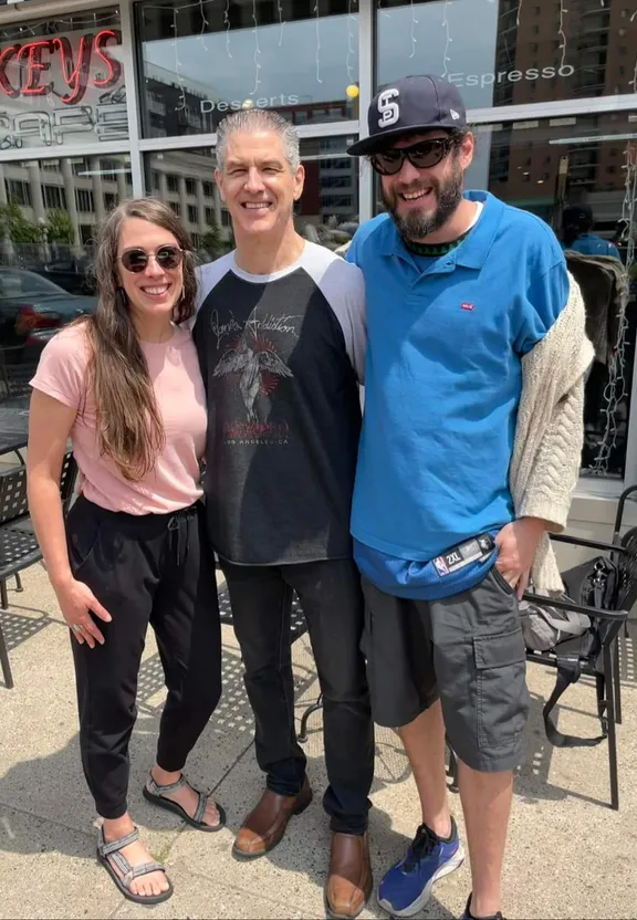 a man and two women standing next to each other