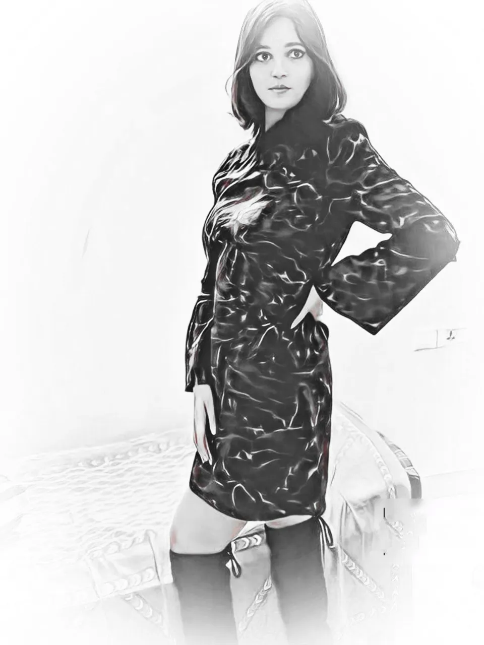 a black and white photo of a woman in boots