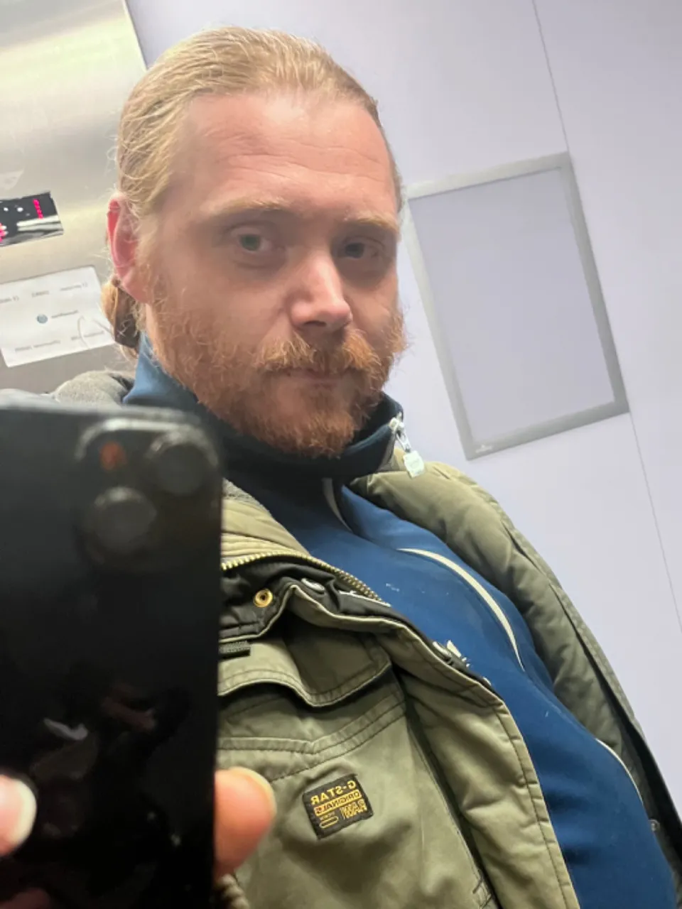 Ultra detailed and highly realistic muppetshow puppet character with long ginger hair in a bun holding a cellphone and taking a picture in a mirror, intricate and detailed muppet character, stunning, epic, 