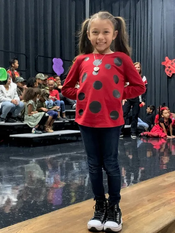 a little girl wearing colorful snowboard gear