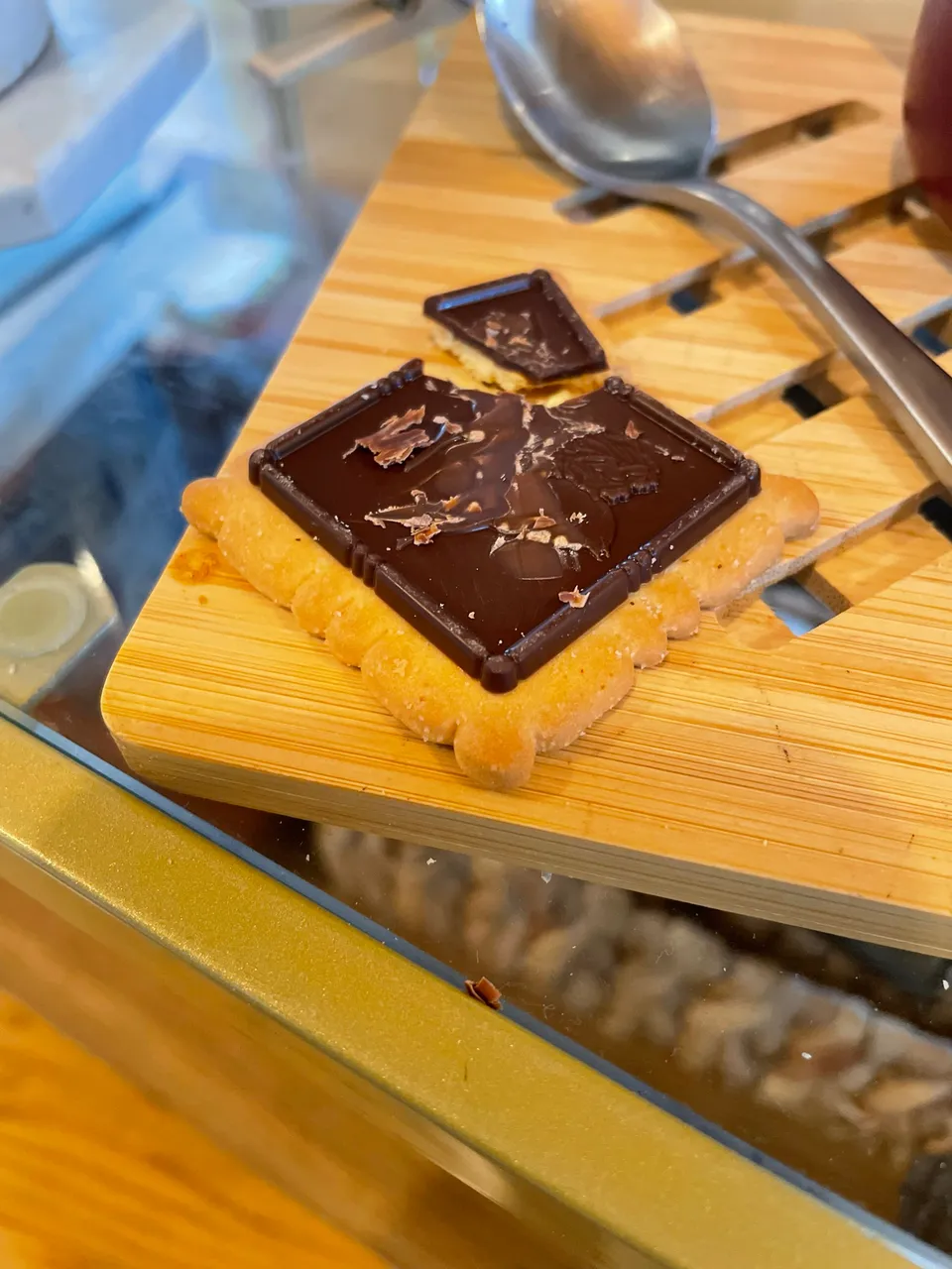 a wooden cutting board topped with a piece of chocolate