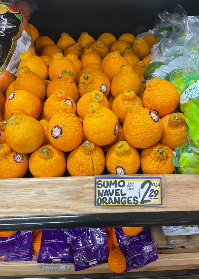 a display in a store filled with lots of oranges